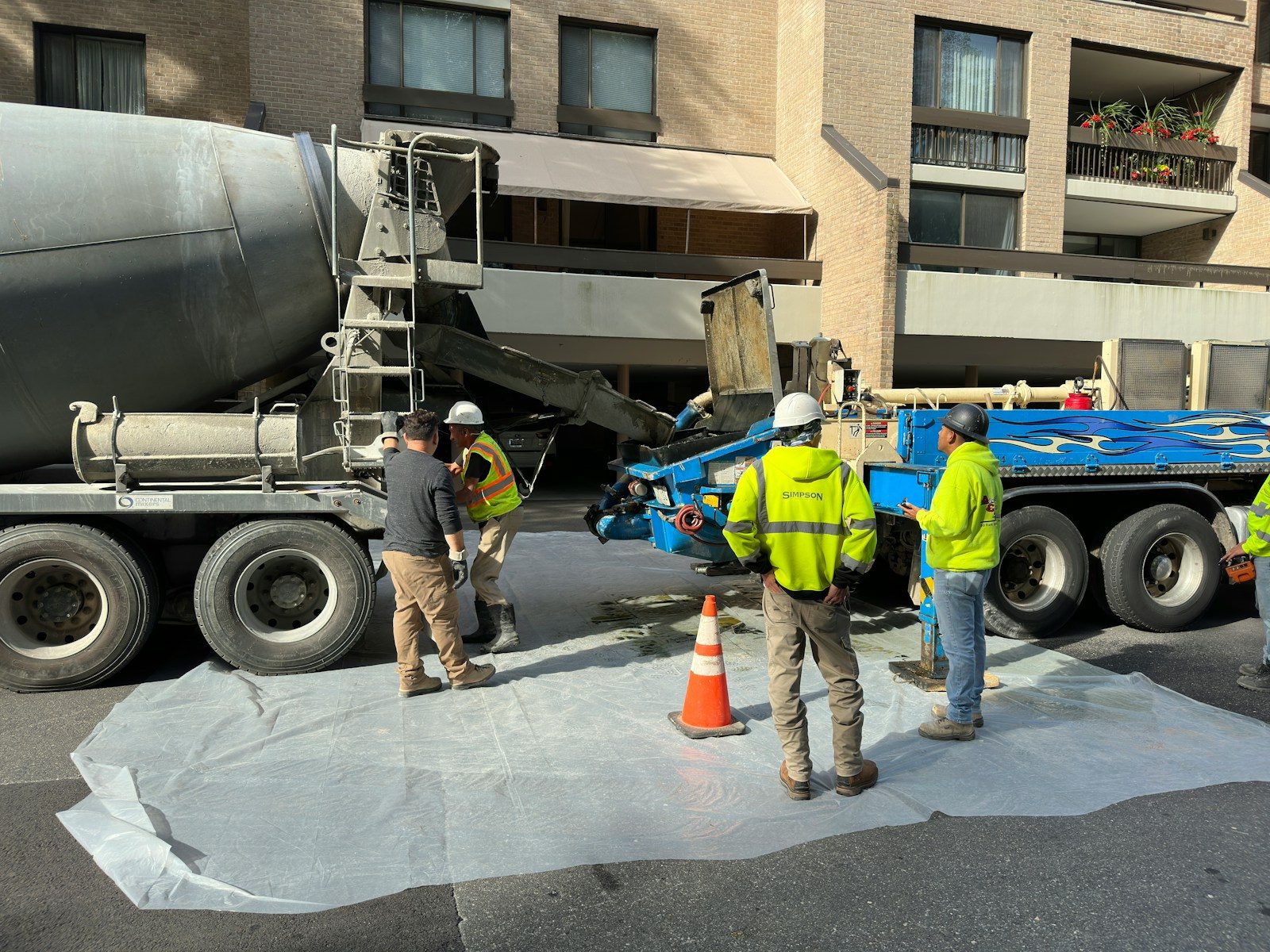 A crew standing next to a cement truck
